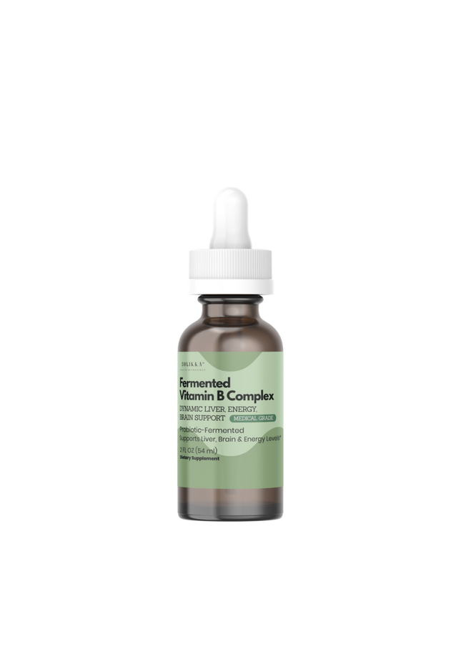 A small amber glass dropper bottle with a white cap and a pale green label, centered on a plain white background. The label text appears to read 'Soyfermented Vitamin B Complex'.