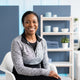 A smiling, diverse athlete in a bright, modern studio space representing a satisfied customer.